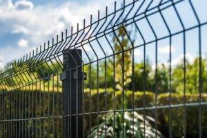 Security fencing with bushes and greenery behind